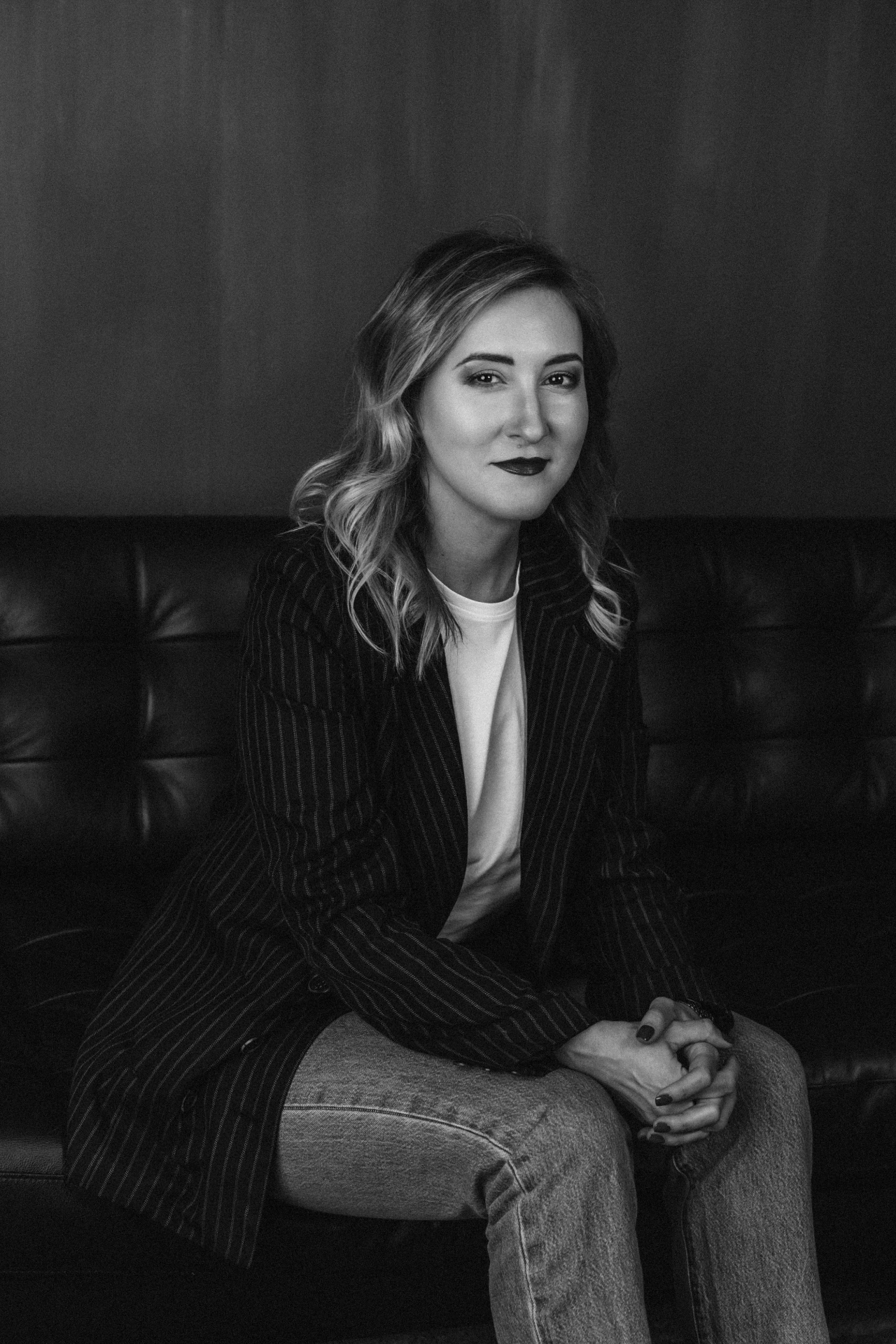Maria Belitskaya, Executive Coach, in black and white portrait wearing pinstripe blazer